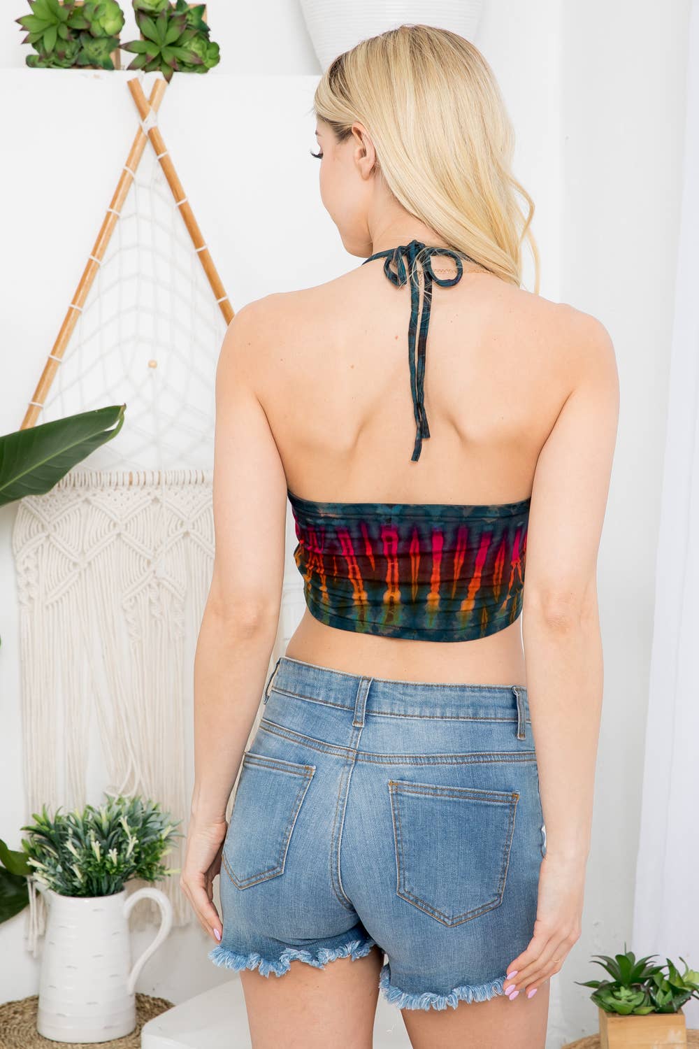 Multicolor tie dye halter crop top with keyhole cutout front styled with denim shorts boho festival outfit
